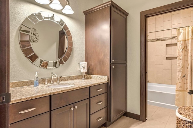 335 Bella Way, Sun Prairie, WI 53590 - bathroom featuring vanity, tile patterned floors, a textured wall, shower / bath combo, and baseboards