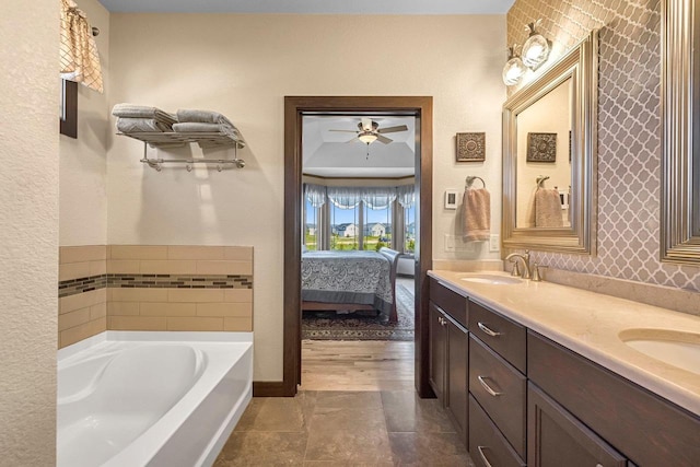 335 Bella Way, Sun Prairie, WI 53590 - full bath with a bath, double vanity, baseboards, ensuite bathroom, and ceiling fan