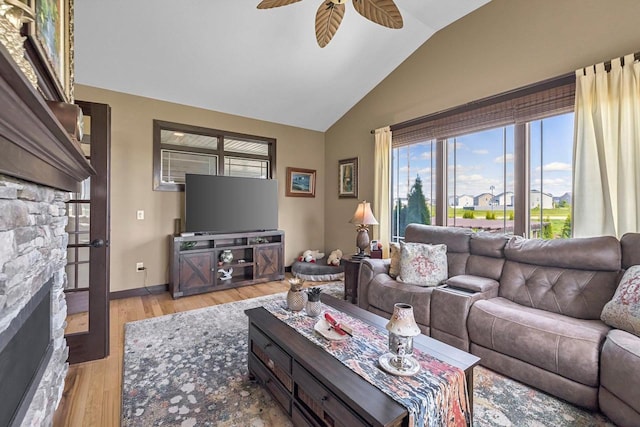 335 Bella Way, Sun Prairie, WI 53590 - living room with plenty of natural light, a ceiling fan, lofted ceiling, light wood-style flooring, and a fireplace