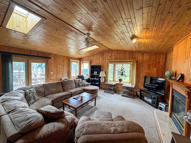 N9960 Meadowlark Ln, Crivitz, WI 54114 - living area with vaulted ceiling, wooden ceiling, wood walls, carpet floors, and a skylight