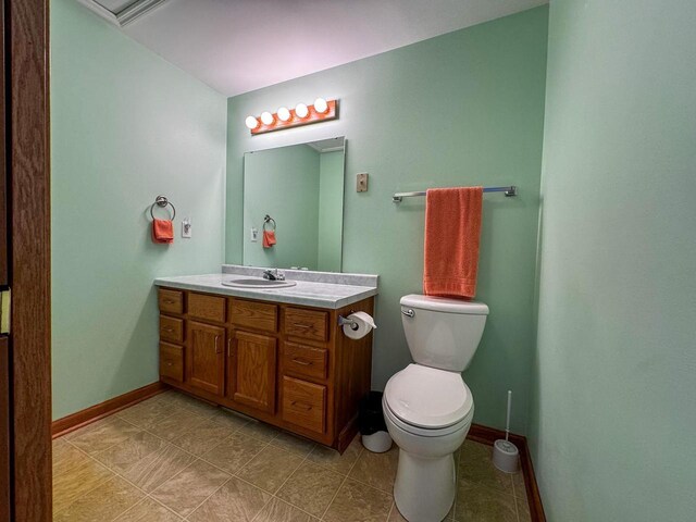 N9960 Meadowlark Ln, Crivitz, WI 54114 - half bath featuring vanity, toilet, baseboards, and tile patterned floors