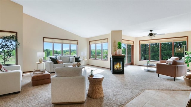 2504 E Princeton Ave, Eau Claire, WI 54703 - living area with a glass covered fireplace, light tile patterned flooring, high vaulted ceiling, light carpet, and ceiling fan