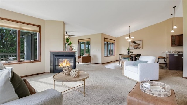 2504 E Princeton Ave, Eau Claire, WI 54703 - living room featuring light carpet, a chandelier, baseboards, a multi sided fireplace, and lofted ceiling