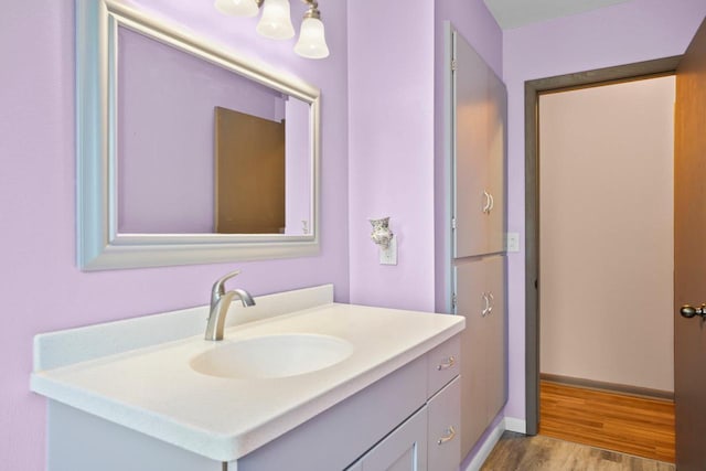 308 Maple Dr, Mount Horeb, WI 53572 - bathroom with vanity, wood finished floors, and baseboards