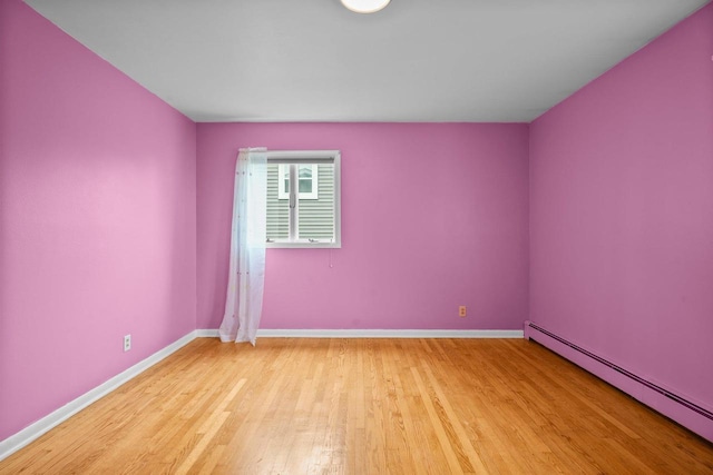 308 Maple Dr, Mount Horeb, WI 53572 - unfurnished room with a baseboard radiator, light wood-style flooring, and baseboards