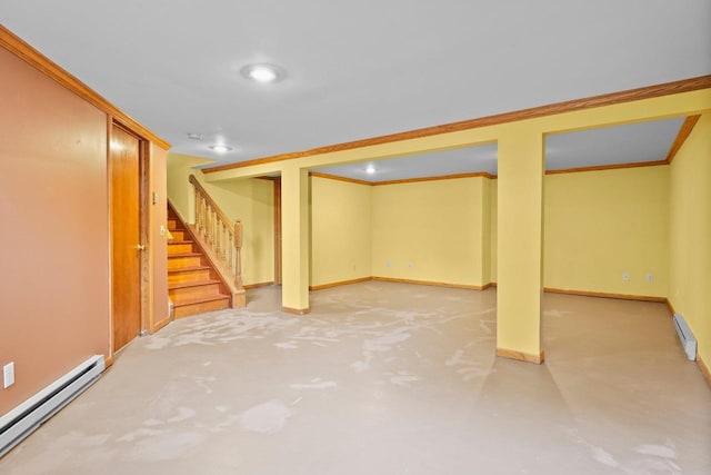 308 Maple Dr, Mount Horeb, WI 53572 - finished basement featuring a baseboard heating unit, stairs, baseboard heating, baseboards, and ornamental molding