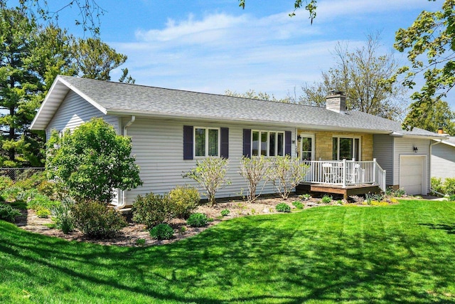 308 Maple Dr, Mount Horeb, WI 53572 - ranch-style house featuring a wooden deck, a chimney, a front yard, a garage, and roof with shingles