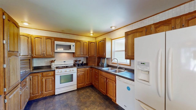 602 W Carol St, Colby, WI 54421 - kitchen featuring white appliances, a sink, brown cabinetry, dark countertops, and decorative backsplash