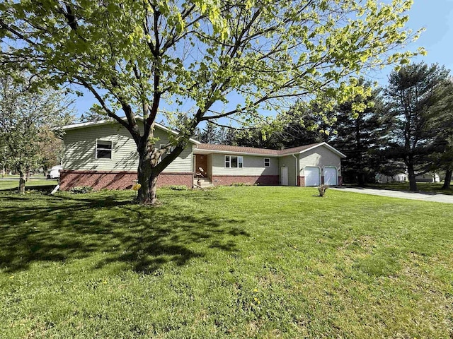 602 W Carol St, Colby, WI 54421 - view of front of property with a garage, brick siding, concrete driveway, and a front yard
