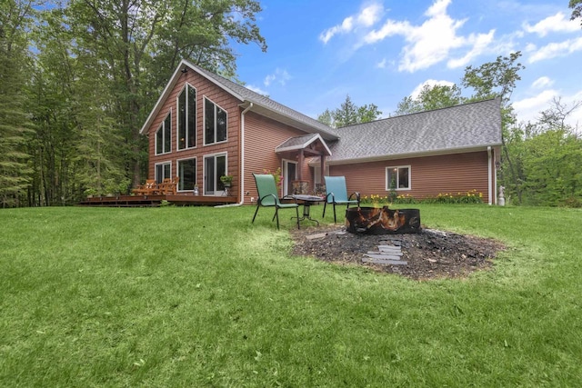 9232 W Lake Dr, Pound, WI 54161 - back of property with a yard, a wooden deck, an outdoor fire pit, and roof with shingles