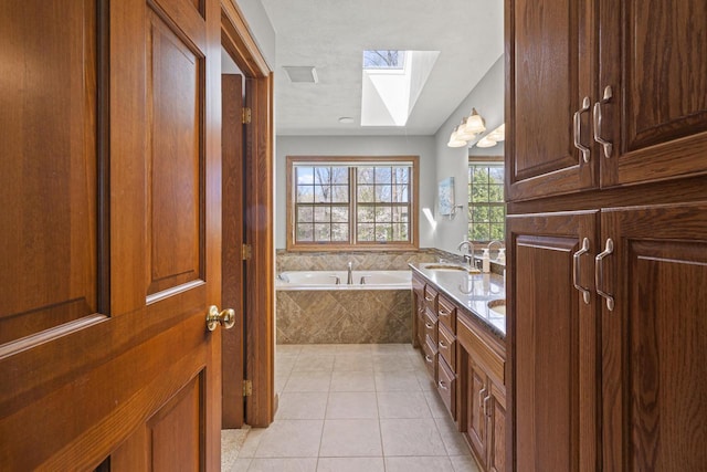 918 E Kramer Ln, Appleton, WI 54915 - bathroom featuring a skylight, tile patterned floors, a garden tub, and double vanity