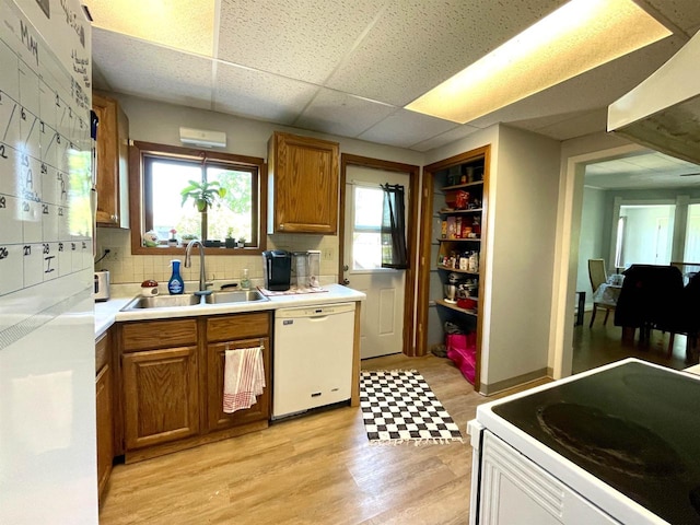 108 S Center St, Orfordville, WI 53576 - kitchen with white appliances, a sink, brown cabinets, light wood finished floors, and a drop ceiling
