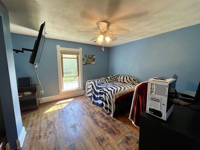 108 S Center St, Orfordville, WI 53576 - bedroom with hardwood / wood-style flooring, baseboards, and a ceiling fan