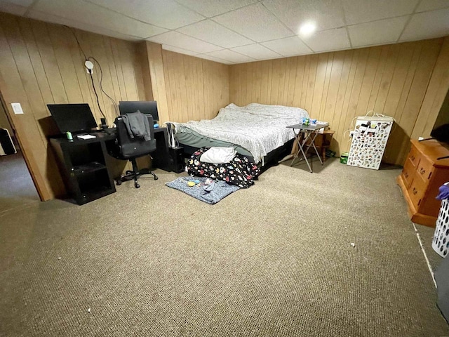 108 S Center St, Orfordville, WI 53576 - carpeted bedroom featuring wood walls, a paneled ceiling, and an office area