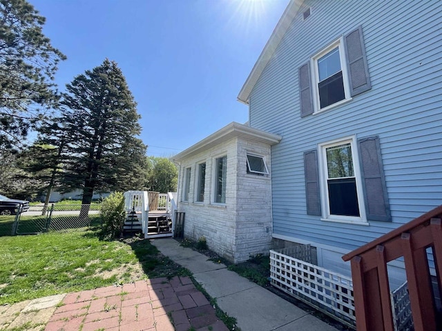 108 S Center St, Orfordville, WI 53576 - view of side of home with stone siding and a deck