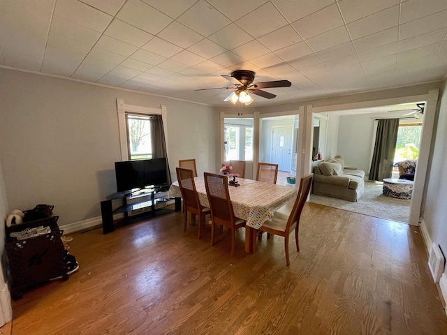 108 S Center St, Orfordville, WI 53576 - dining room featuring ceiling fan, wood finished floors, crown molding, and baseboards