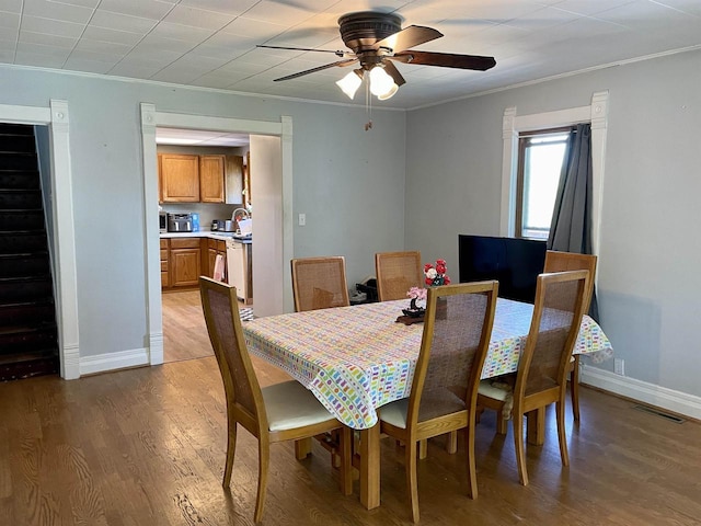108 S Center St, Orfordville, WI 53576 - dining room with ornamental molding, light wood-type flooring, baseboards, a ceiling fan, and stairway
