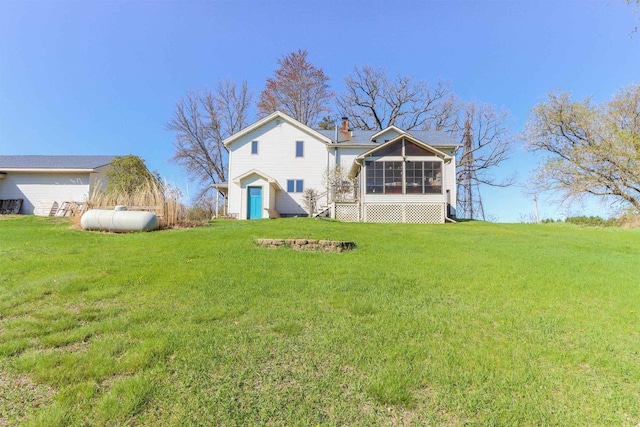 N4618 State Road 49, Waupaca, WI 54981 - rear view of property with a sunroom, a lawn, and a chimney