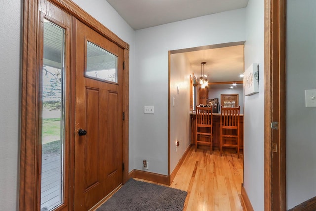 N4618 State Road 49, Waupaca, WI 54981 - foyer featuring light wood-type flooring, baseboards, and a chandelier