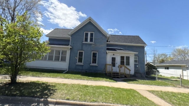 traditional-style home featuring a front yard