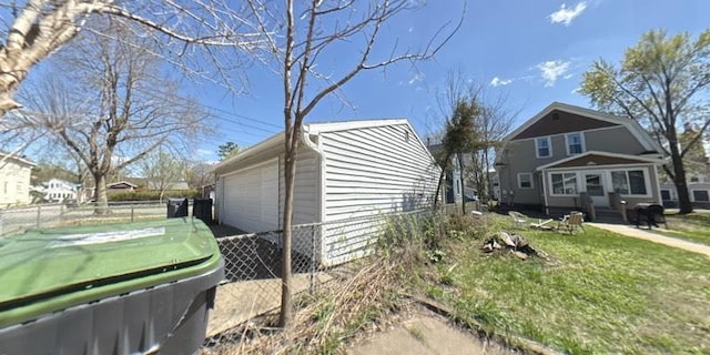 view of side of property featuring a detached garage and an outdoor structure