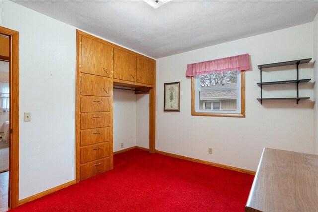 1408 S Hemlock Ave, Marshfield, WI 54449 - unfurnished bedroom with dark carpet, baseboards, and a closet