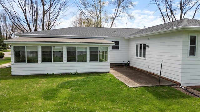 1408 S Hemlock Ave, Marshfield, WI 54449 - back of property with a lawn, a patio area, a sunroom, and a shingled roof