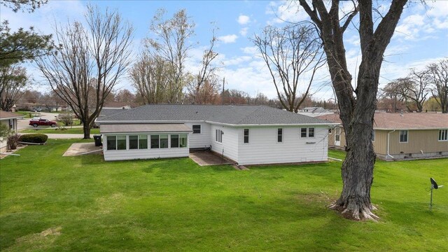 1408 S Hemlock Ave, Marshfield, WI 54449 - rear view of property with a yard and a sunroom