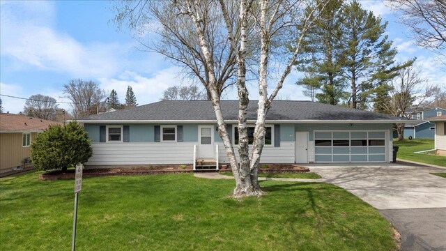 1408 S Hemlock Ave, Marshfield, WI 54449 - view of front of house featuring a garage, concrete driveway, a front lawn, and roof with shingles