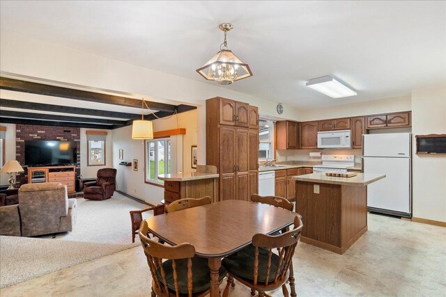 1408 S Hemlock Ave, Marshfield, WI 54449 - dining space featuring a chandelier, beamed ceiling, and baseboards
