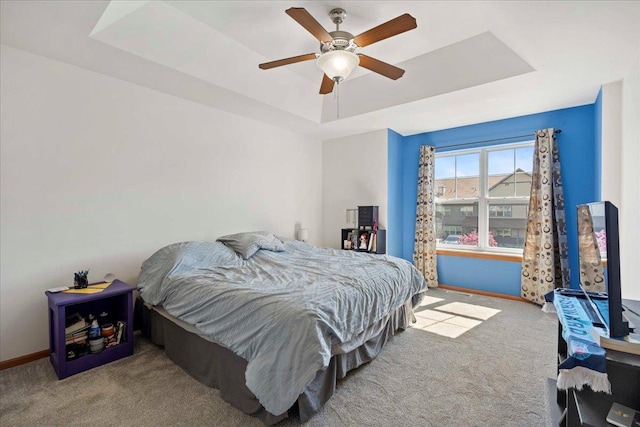 1119 Enterprise Dr, Verona, WI 53593 - bedroom featuring a tray ceiling, carpet floors, baseboards, and ceiling fan