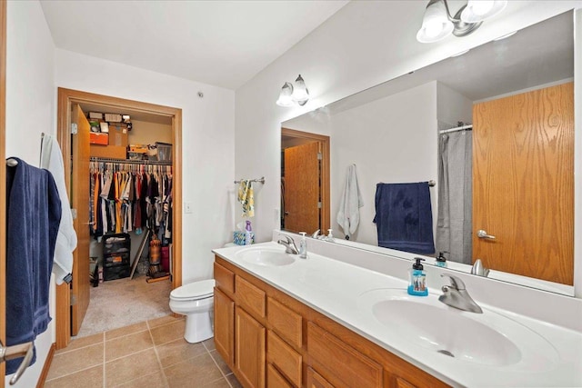 1119 Enterprise Dr, Verona, WI 53593 - bathroom featuring toilet, double vanity, curtained shower, tile patterned flooring, and a spacious closet