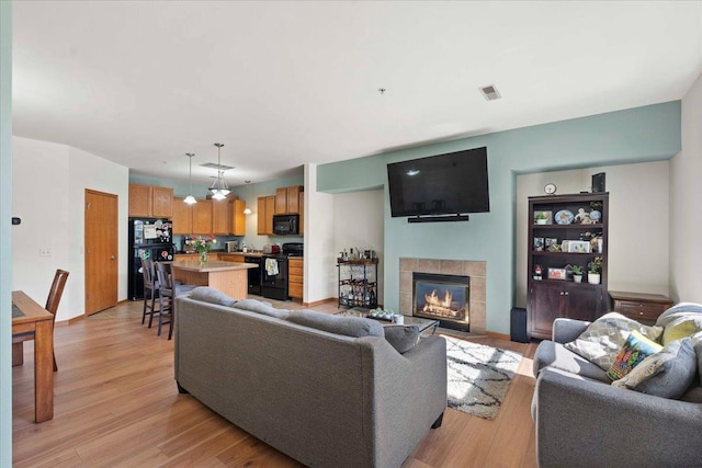 1119 Enterprise Dr, Verona, WI 53593 - living room featuring a tile fireplace and light wood finished floors