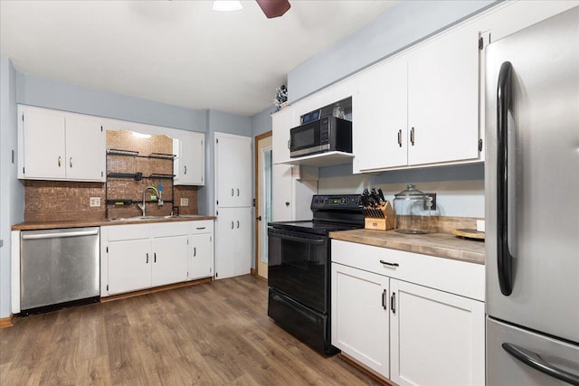 1528 Jefferson St, West Bend, WI 53090 - kitchen with black appliances, dark wood-type flooring, backsplash, white cabinetry, and a sink