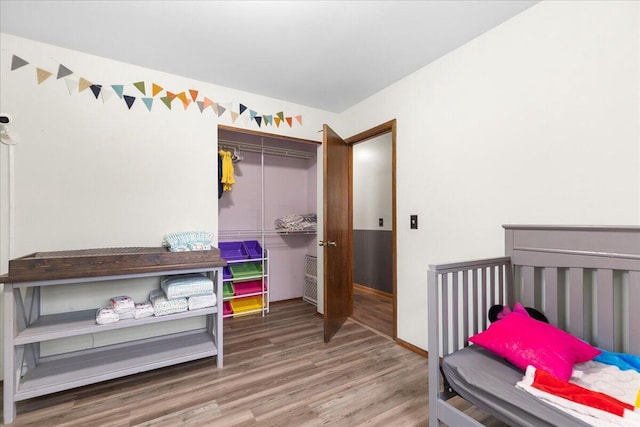 1528 Jefferson St, West Bend, WI 53090 - bedroom with a closet, wood finished floors, and baseboards