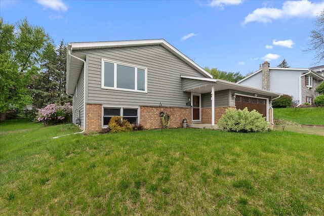1528 Jefferson St, West Bend, WI 53090 - tri-level home featuring an attached garage, a front yard, and brick siding