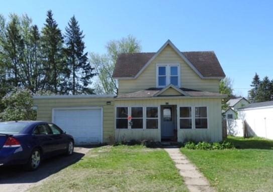 818 W Main St, Augusta, WI 54722 - view of front of property with an attached garage, asphalt driveway, and a front lawn