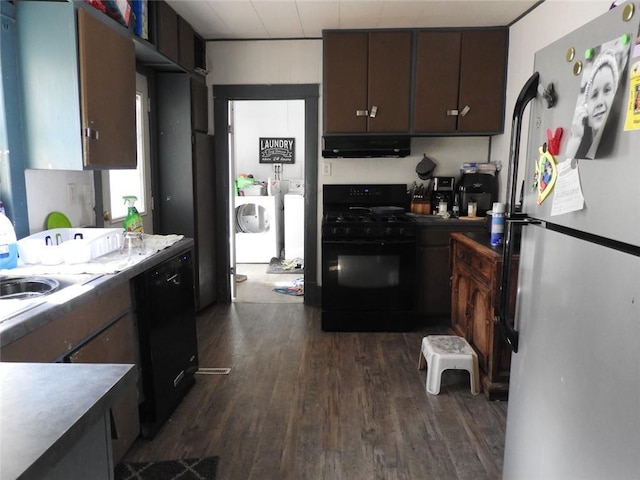 818 W Main St, Augusta, WI 54722 - kitchen featuring black appliances, exhaust hood, dark wood-style floors, and washer and clothes dryer