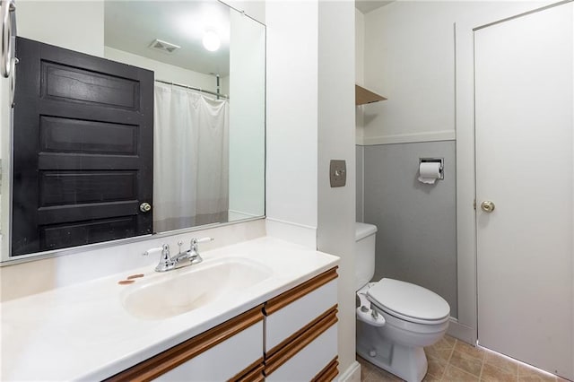 full bathroom featuring vanity, toilet, and baseboards