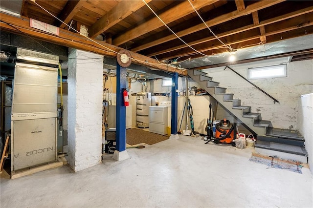 below grade area featuring washer / clothes dryer, stairway, and water heater