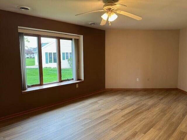 1521 Raveen St, Fort Atkinson, WI 53538 - spare room with light wood-type flooring, baseboards, and a ceiling fan