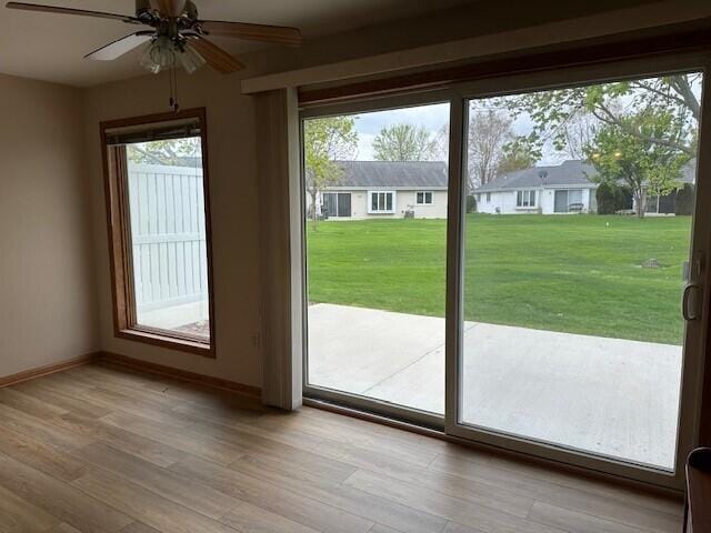 1521 Raveen St, Fort Atkinson, WI 53538 - doorway with a ceiling fan, light wood-style flooring, and baseboards