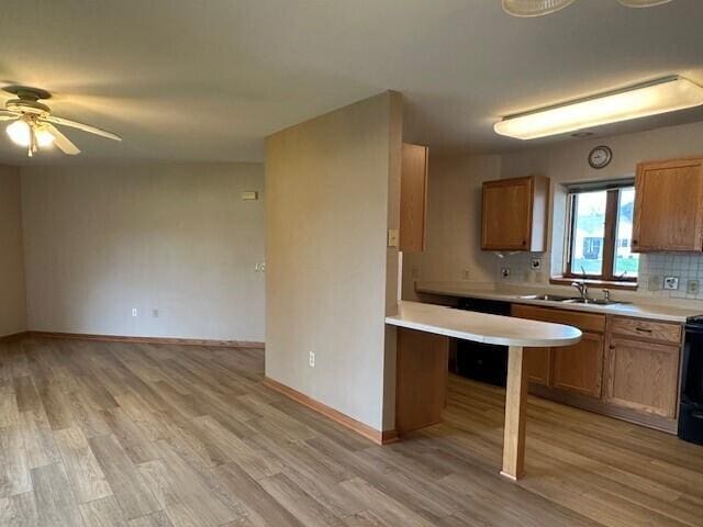 1521 Raveen St, Fort Atkinson, WI 53538 - kitchen with a sink, light countertops, light wood-style floors, and ceiling fan