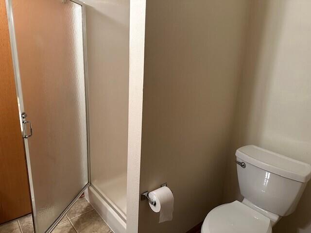 1521 Raveen St, Fort Atkinson, WI 53538 - full bathroom with a shower stall, toilet, and tile patterned floors