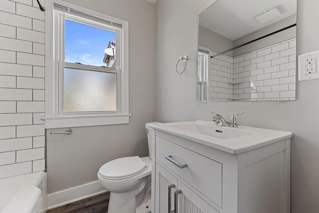 full bathroom with toilet, plenty of natural light, vanity, and wood finished floors