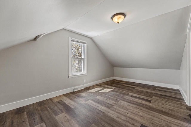 bonus room featuring vaulted ceiling, wood finished floors, and baseboards