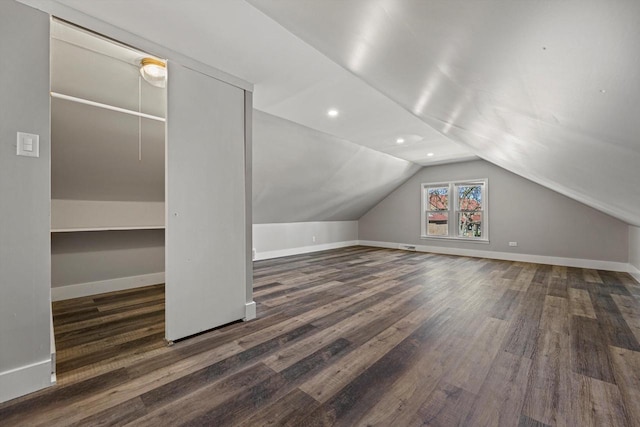 additional living space featuring wood finished floors, vaulted ceiling, baseboards, and recessed lighting