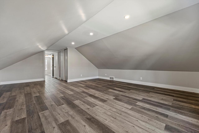 bonus room with lofted ceiling, dark wood-style flooring, baseboards, and recessed lighting