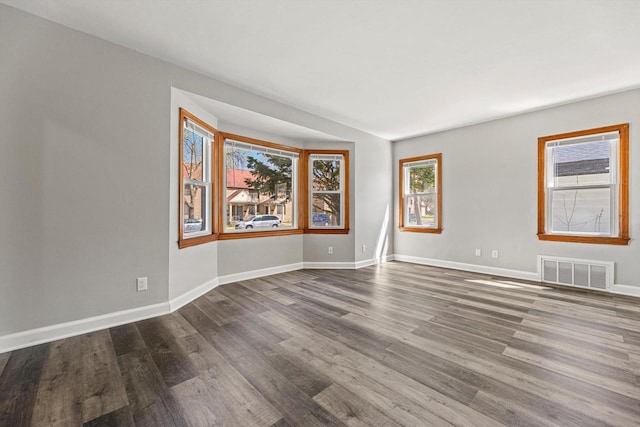 empty room with wood finished floors and baseboards