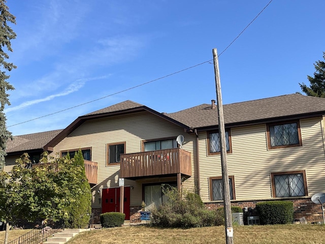 6010 W Calumet Rd Unit 101A, Milwaukee, WI 53223 - back of house with a balcony, brick siding, and roof with shingles